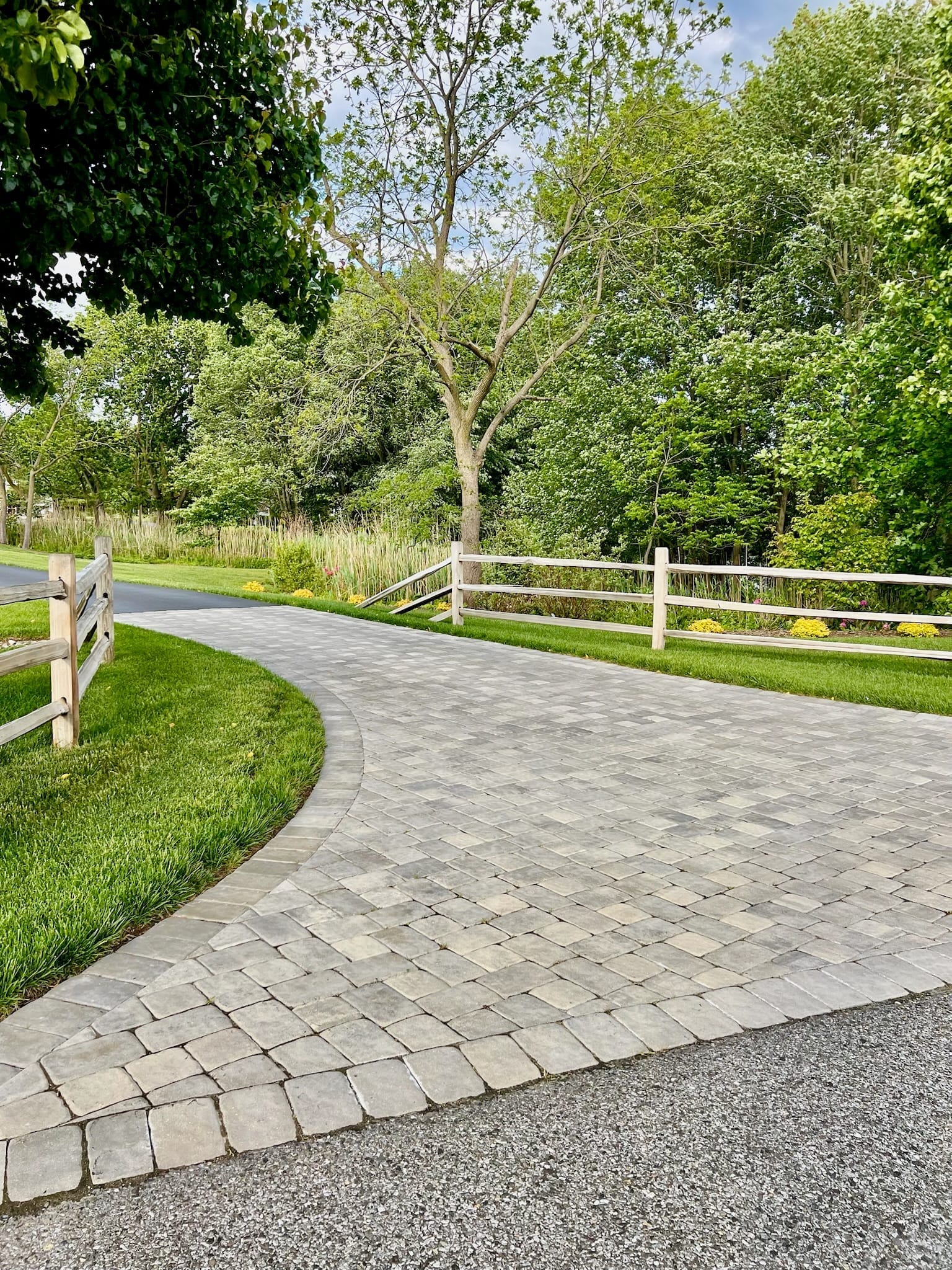 Paver driveway with split-rail fence