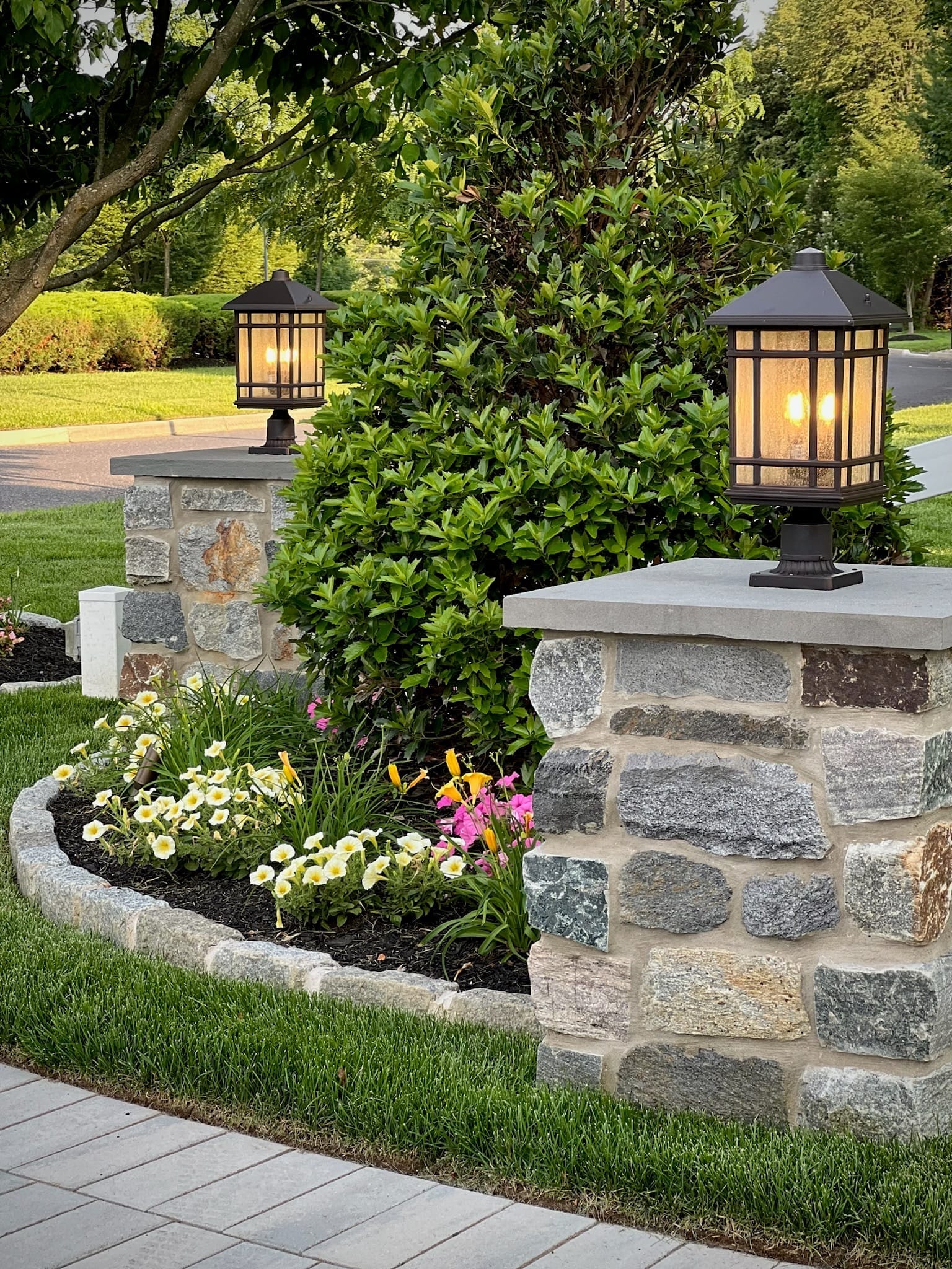 Stone columns with craftsman lanterns at dusk